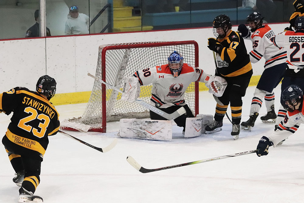 Thunderbirds complete weekend sweep of Eagles 30 Thunderbirds goalie makes a big save against Eagles forward Logan Stawizynski (#23)